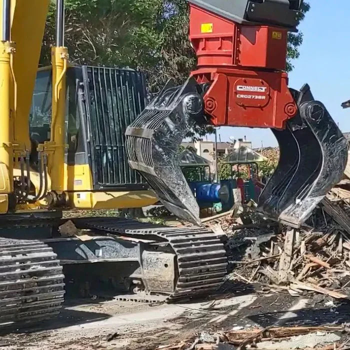 Excavator with a Connect Work Tools Grapple attachment working at recycling plant. Image featured on Construction Tools Direct product page.