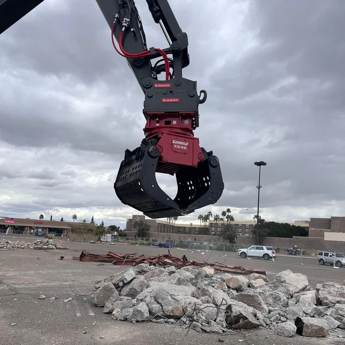 Excavator with connect work tools grapple on a jobsite 