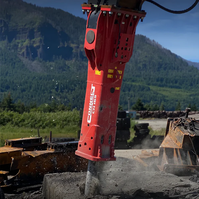 Red hydraulic breaker with "Connect Work Tools" branding against a mountainous landscape.