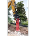 Excavator with a red hydraulic breaker attachment in an outdoor setting.
