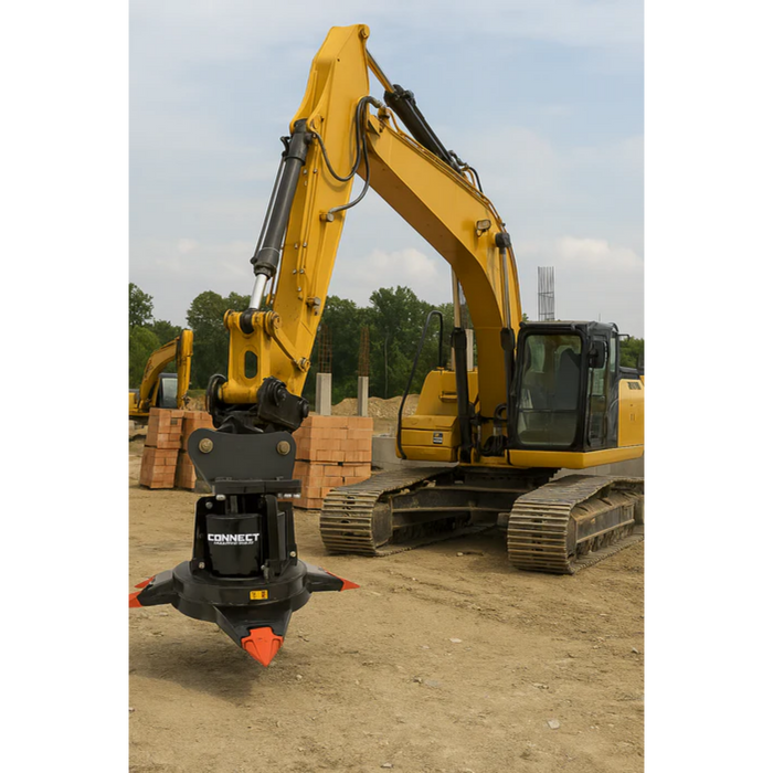 Yellow excavator with a hydraulic magnet attachment on a construction site.
