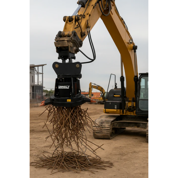 Excavator with a hydraulic magnet attachment on a construction site raising rebar from the ground