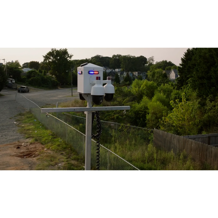 solar security cameras with red and blue lights on a rural road.