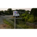 solar security cameras with red and blue lights on a rural road.