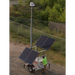 Solar-powered security camera trailer with two large solar panels, with a person operating it outdoors.