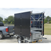 mobile solar security camera trailer being pulled by gray truck