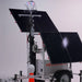 Solar-powered security camera trailer with light tower and multiple solar panels on a white background