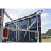 Trailer with a large solar panel on the back, under a clear blue sky.
