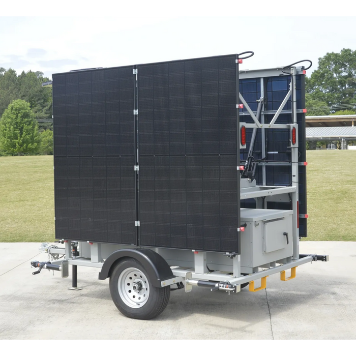 Mobile solar security camera trailer with solar panels on a trailer in an outdoor setting