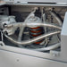 Close-up of mechanical components with pipes and springs inside a machine.